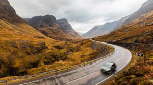Car driving through Scottish Highlands